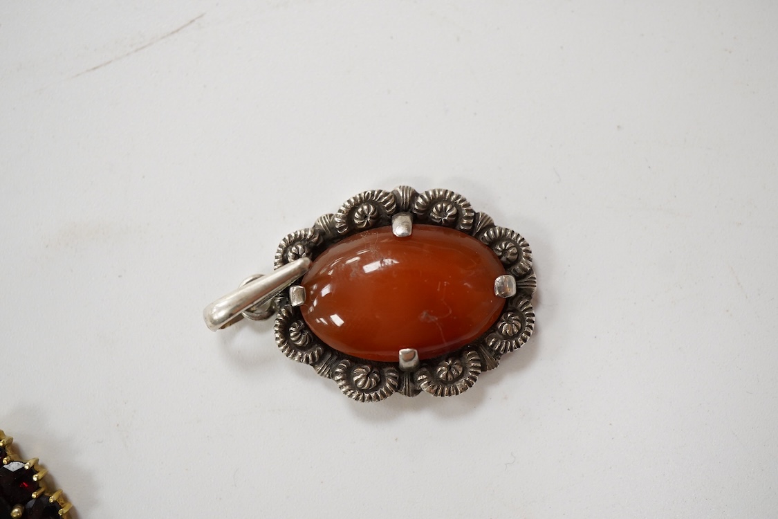 An 800 standard gilt white metal and garnet cluster set oval pendant, 18mm, on a 585 yellow metal fine link chain, 2.5 grams, a gilt white metal and garnet cluster set hinged bangle, two white metal brooches including on